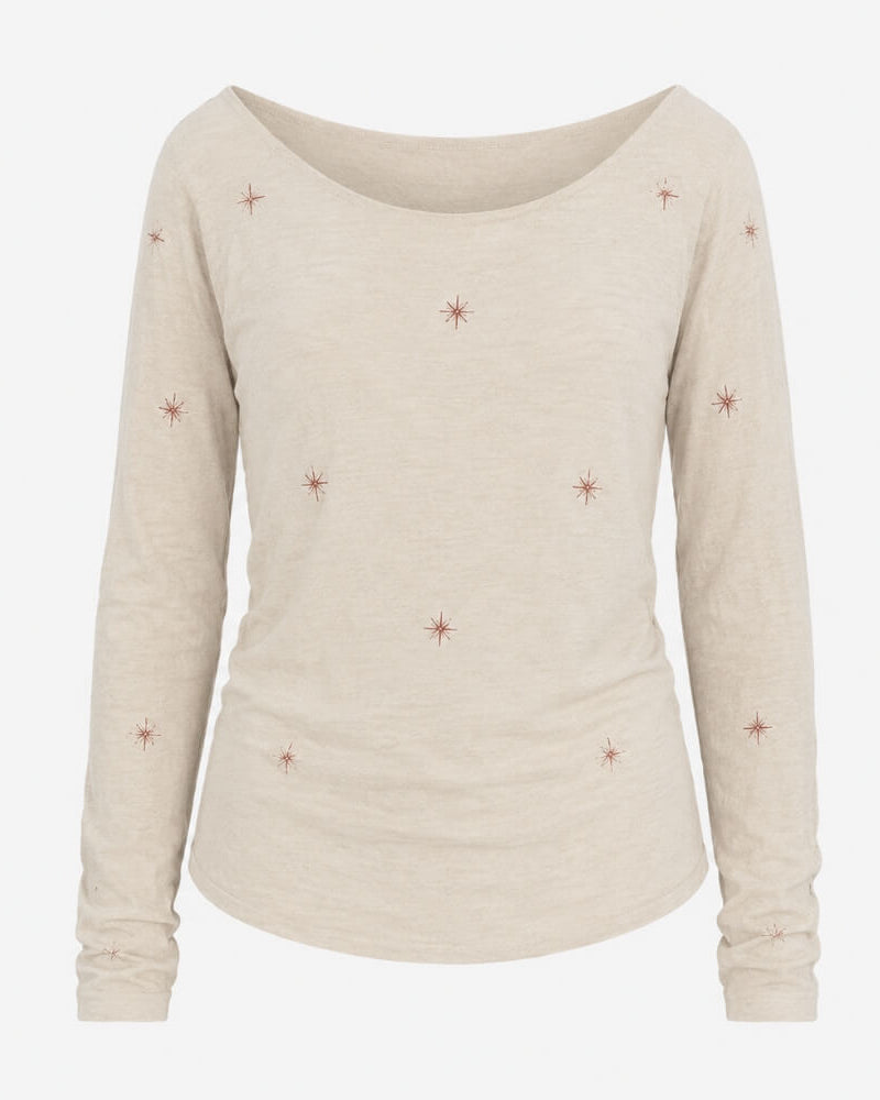 Estrania top by Lunaré – back view, cream long-sleeve top with wide boat neckline and hand-embroidered rust star motifs, 100% cotton.