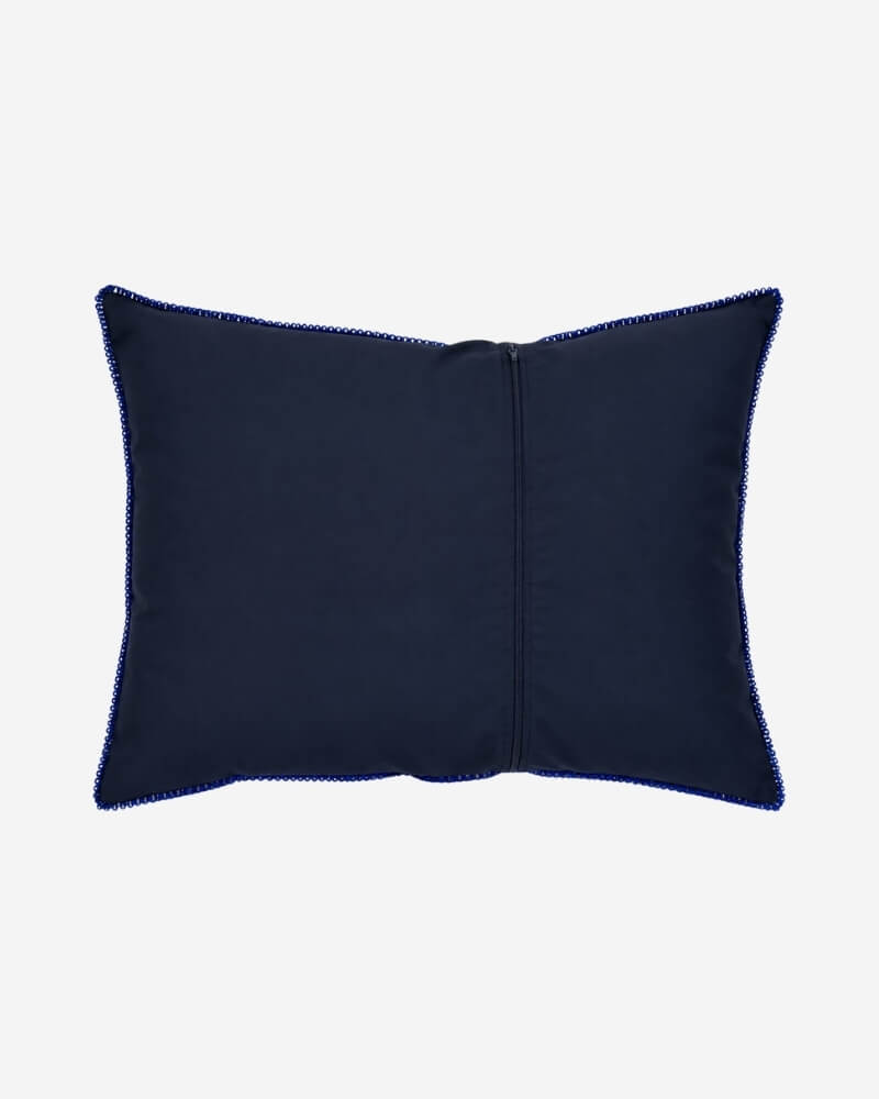 Hand-Embroidered Shipibo Cushion No. 13 by Lunaré – back view, plain navy fabric with blue zigzag stitch trim.