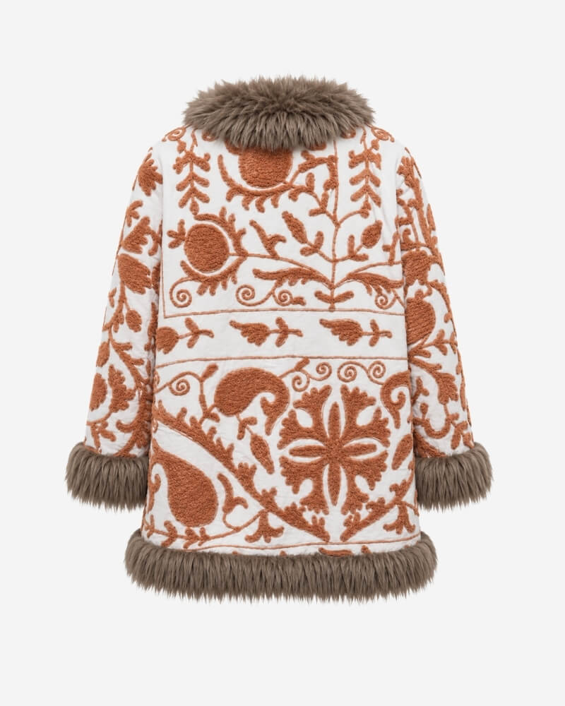 The Afghan Coat Jasmia No. 1 by Lunaré – back view showing the full rust hand-embroidered vine and floral medallion pattern on cream fabric with taupe shaggy shearling collar and cuffs.
