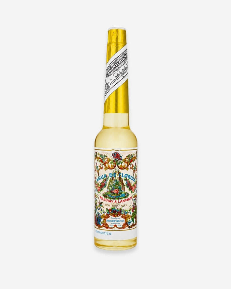 Murray & Lanman Agua de Kananga bottle, yellow-gold liquid with an ornate, traditional floral label.