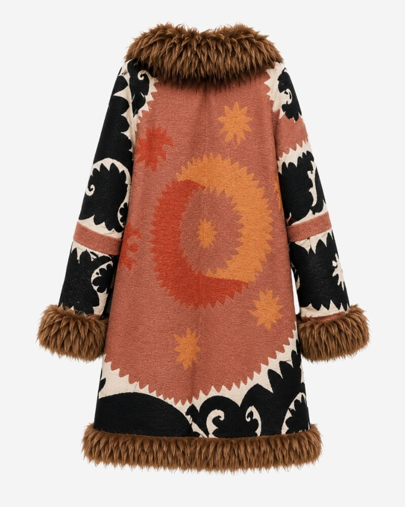 The Afghan Coat Ragna No. 3 by Lunaré – back view with a bold rust and orange sunburst medallion on the back panel, black patterned sleeves and camel-toned shaggy shearling trim.