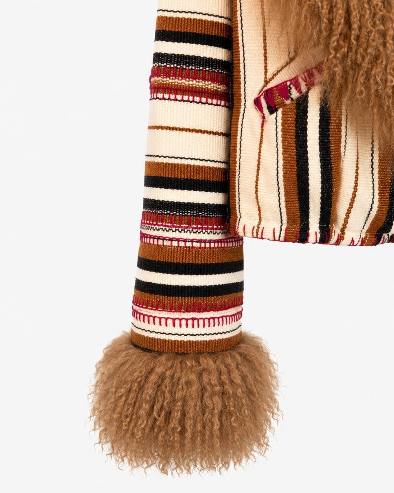 The Afghan Coat Karen No. 1 by Lunaré – close-up detail of the handwoven cream, red and black striped wool sleeve and camel shearling cuff.