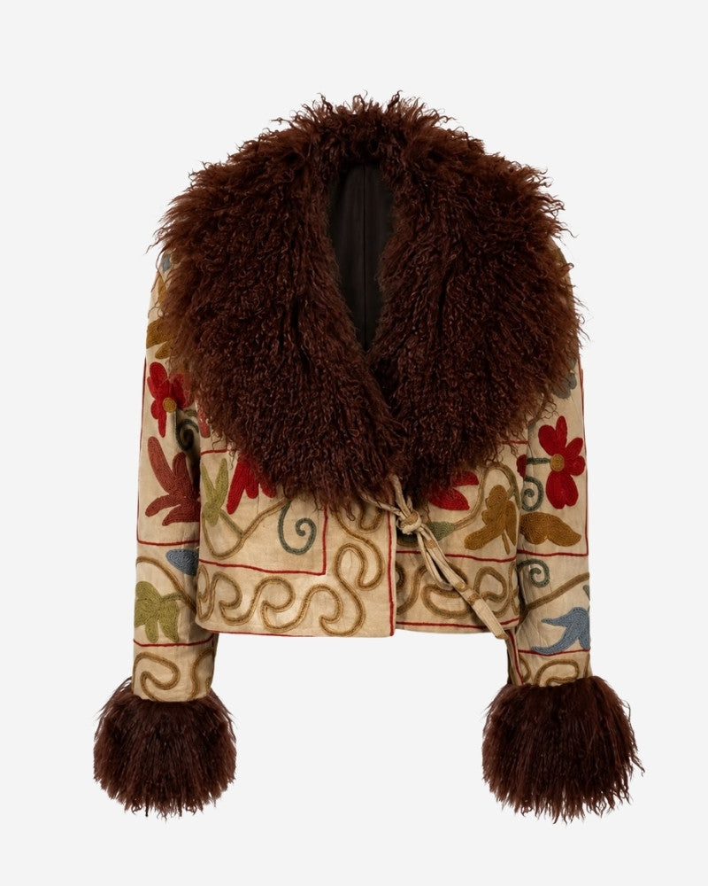 The Afghan Coat Martina No. 12 by Lunaré – front view, cream coat with hand-embroidered floral vine pattern in rust, olive and blue, brown shaggy shearling collar and cuffs.