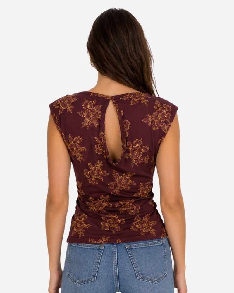 Nube Top 1 by Lunaré – back view on model, burgundy floral print sleeveless top with keyhole cutout.