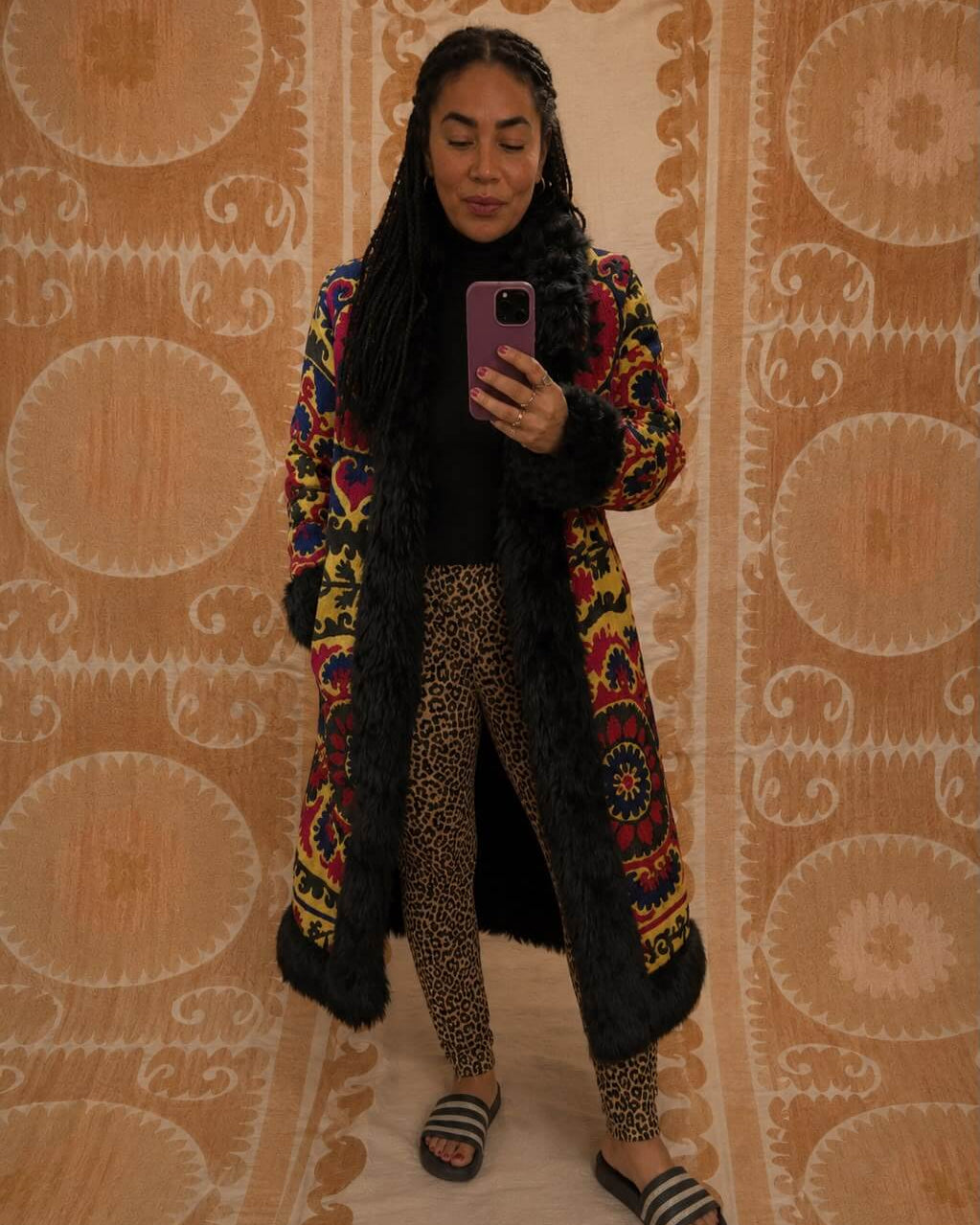 Ragna Coat by Lunaré – mirror selfie on model, embroidered coat with colorful floral pattern and black faux fur trim.
