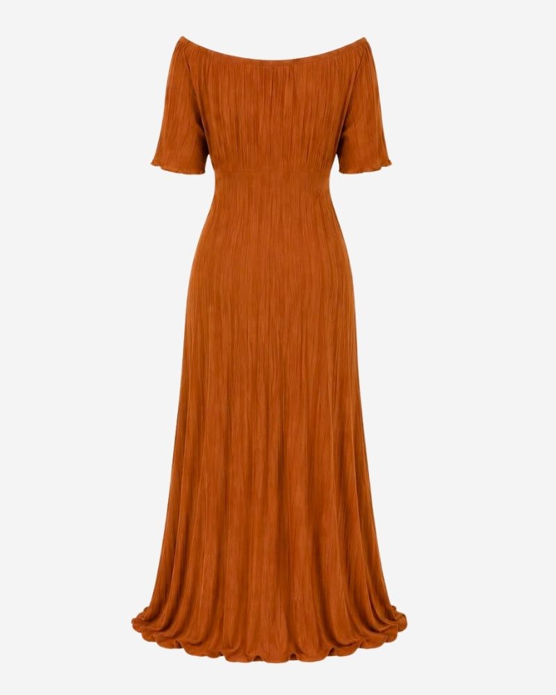 Back view of the Rose Dress in camel ribbed knit, showing the fluted, high-slit hem.