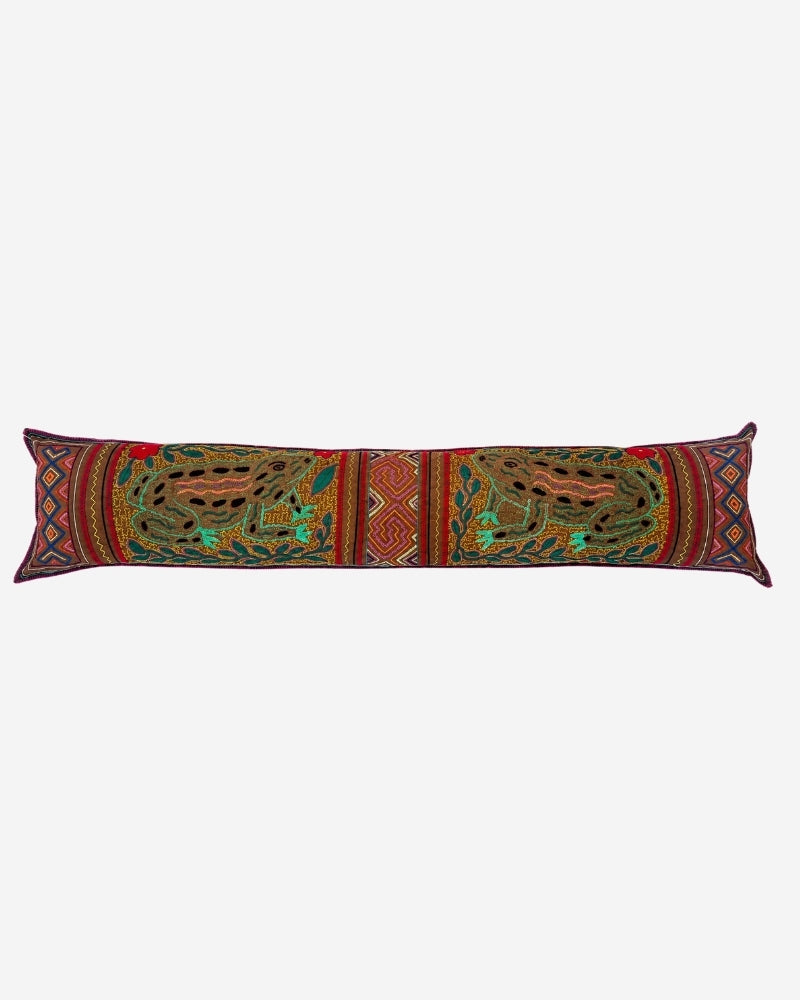 Hand-Embroidered Shipibo Cushion No. 17, long lumbar shape in green and gold, with a repeated frog motif and Kené-inspired border pattern.