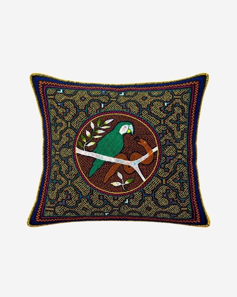 Hand-Embroidered Shipibo Cushion No. 8 in navy, with an intricate geometric maze pattern and a central circular medallion featuring a green parrot on a branch.