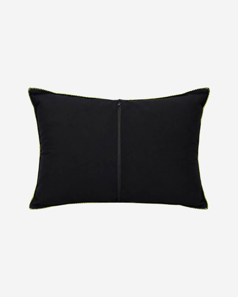 Hand-Embroidered Shipibo Cushion No. 14 by Lunaré – back view, solid black cotton cover with yellow-green contrast piping.