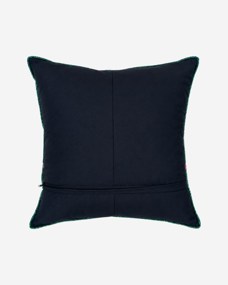 Hand-Embroidered Shipibo Cushion No. 16 by Lunaré – back view, solid navy cotton cover with teal contrast piping along the edges.