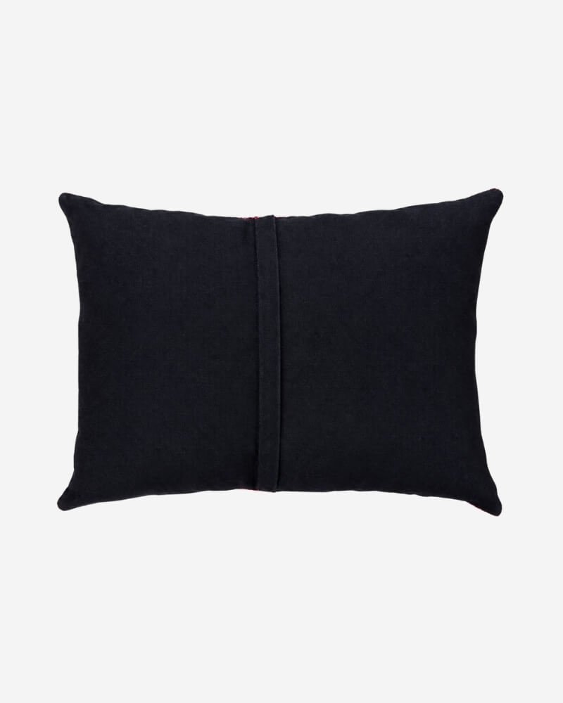 Hand-Embroidered Shipibo Cushion No. 19 by Lunaré – back view, solid black cotton cover.