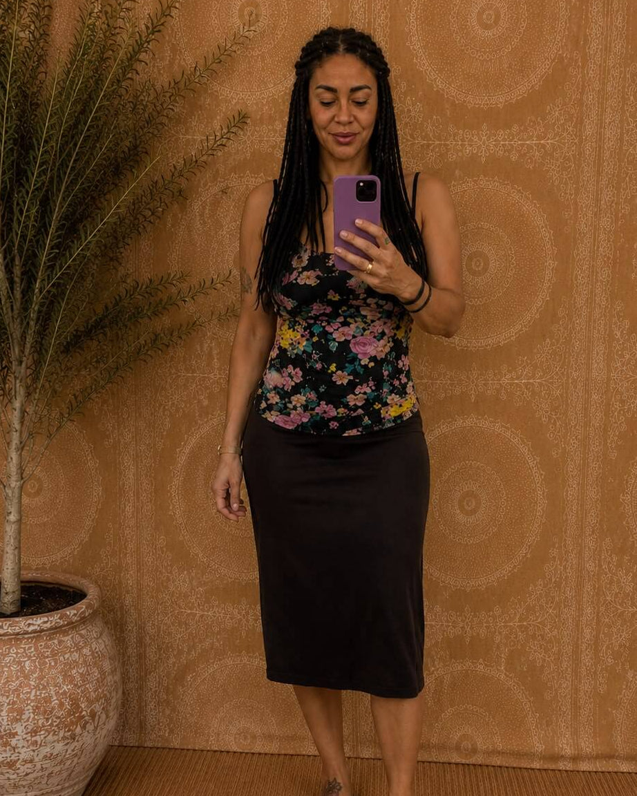 Solita top by Lunaré – lifestyle photo of the black floral camisole top styled with a plain black midi skirt.