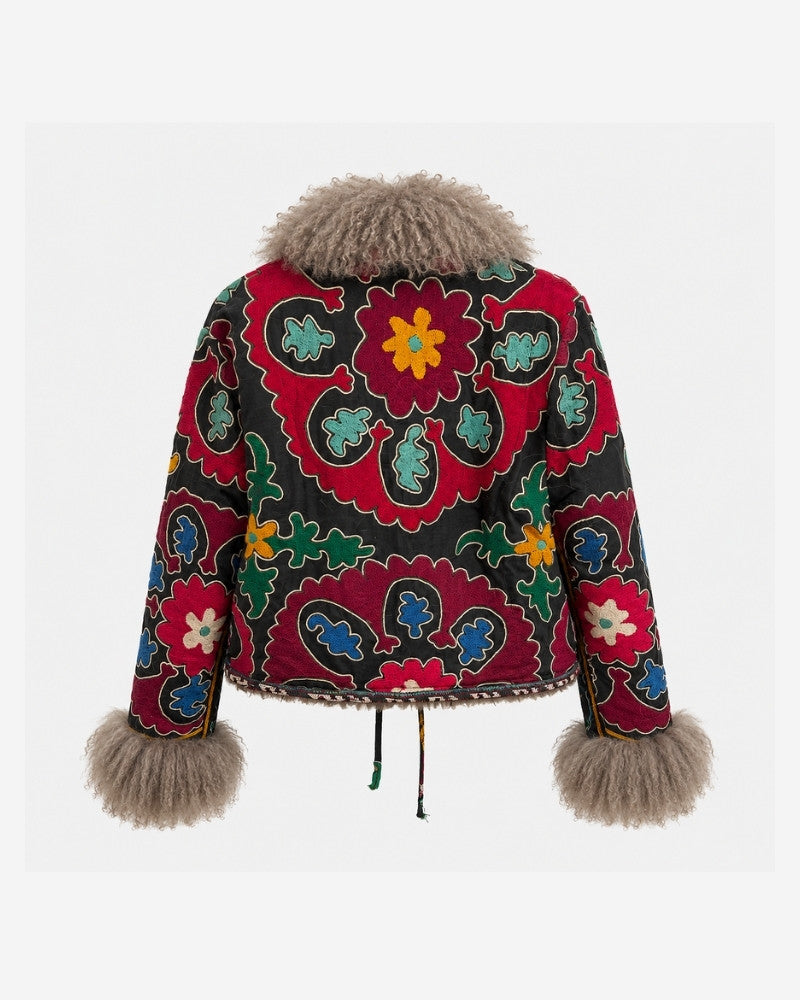The Afghan Coat Martina No. 6 by Lunaré – back view showing the hand-embroidered red and black suzani-style floral pattern and taupe Tibetan lamb fur collar and cuffs.