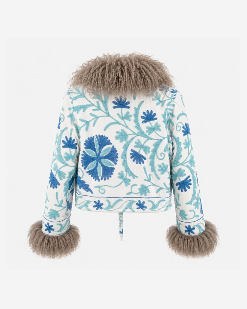 The Afghan Coat Martina No. 7 by Lunaré – back view showing the hand-embroidered blue floral pattern and a soft taupe Tibetan lamb fur collar.