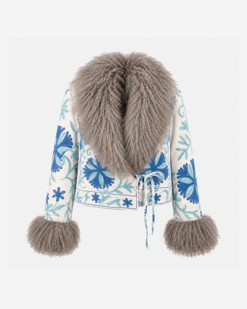The Afghan Coat Martina No. 7 by Lunaré – front view, cream jacket with hand-embroidered blue floral pattern and a soft taupe Tibetan lamb fur collar and cuffs.