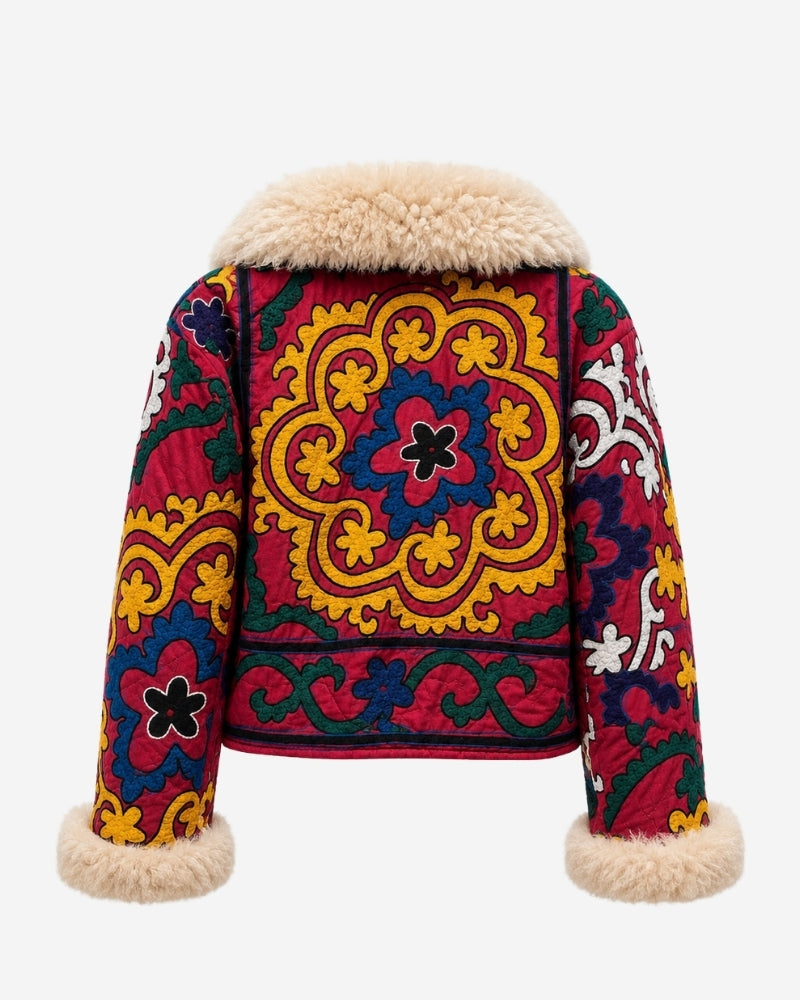 The Afghan Coat Coco No. 3 by Lunaré – back view with a bold gold sunburst medallion and black flower motifs on crimson red, camel shaggy shearling collar and cuffs.