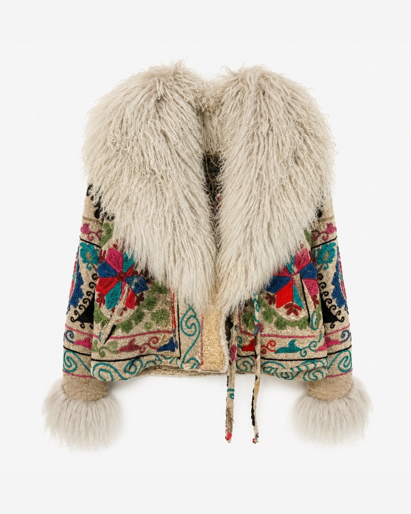 The Martina Coat No. 9, front view, in cream shearling with colourful embroidered star and floral panels in red, blue, teal and green, and a tie waist closure.
