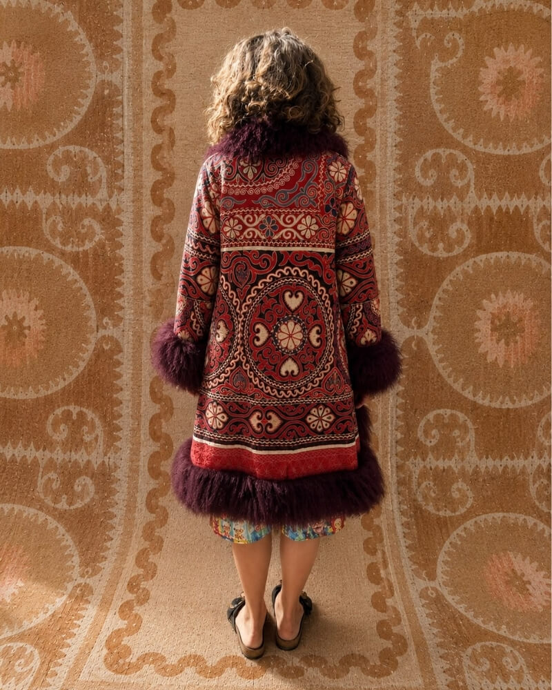 The Afghan Coat Ragna No. 4 by Lunaré – back view on model, multicolor embroidered coat with plum shaggy shearling trim.