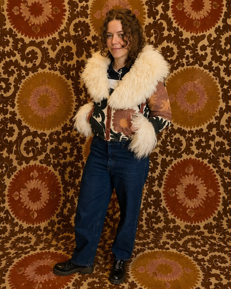 The Afghan Coat Coco No. 1 by Lunaré – front view on model, multicolor patterned coat with cream shaggy shearling collar and cuffs.