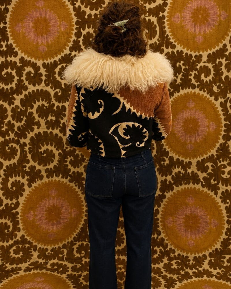 The Afghan Coat Coco No. 1 by Lunaré – back view on model, multicolor patterned coat with cream shaggy shearling collar.