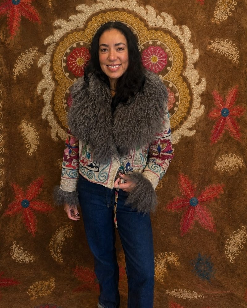 The Afghan Coat Martina No. 3 by Lunaré – on model, cream multicolor floral embroidered coat with grey shaggy shearling collar and cuffs.